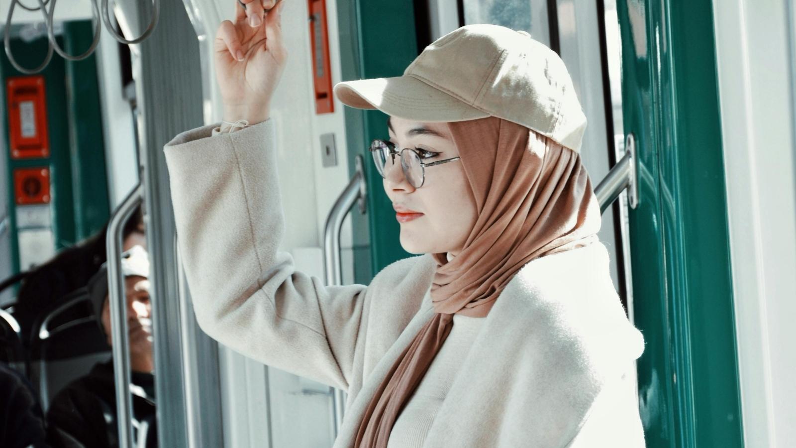 woman wearing a hat on the subway