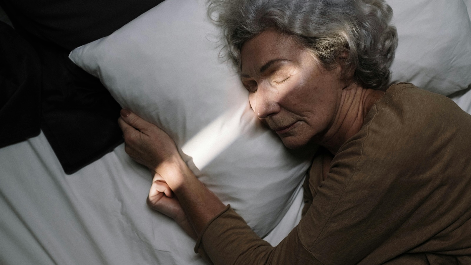elderly woman in bed sleeping