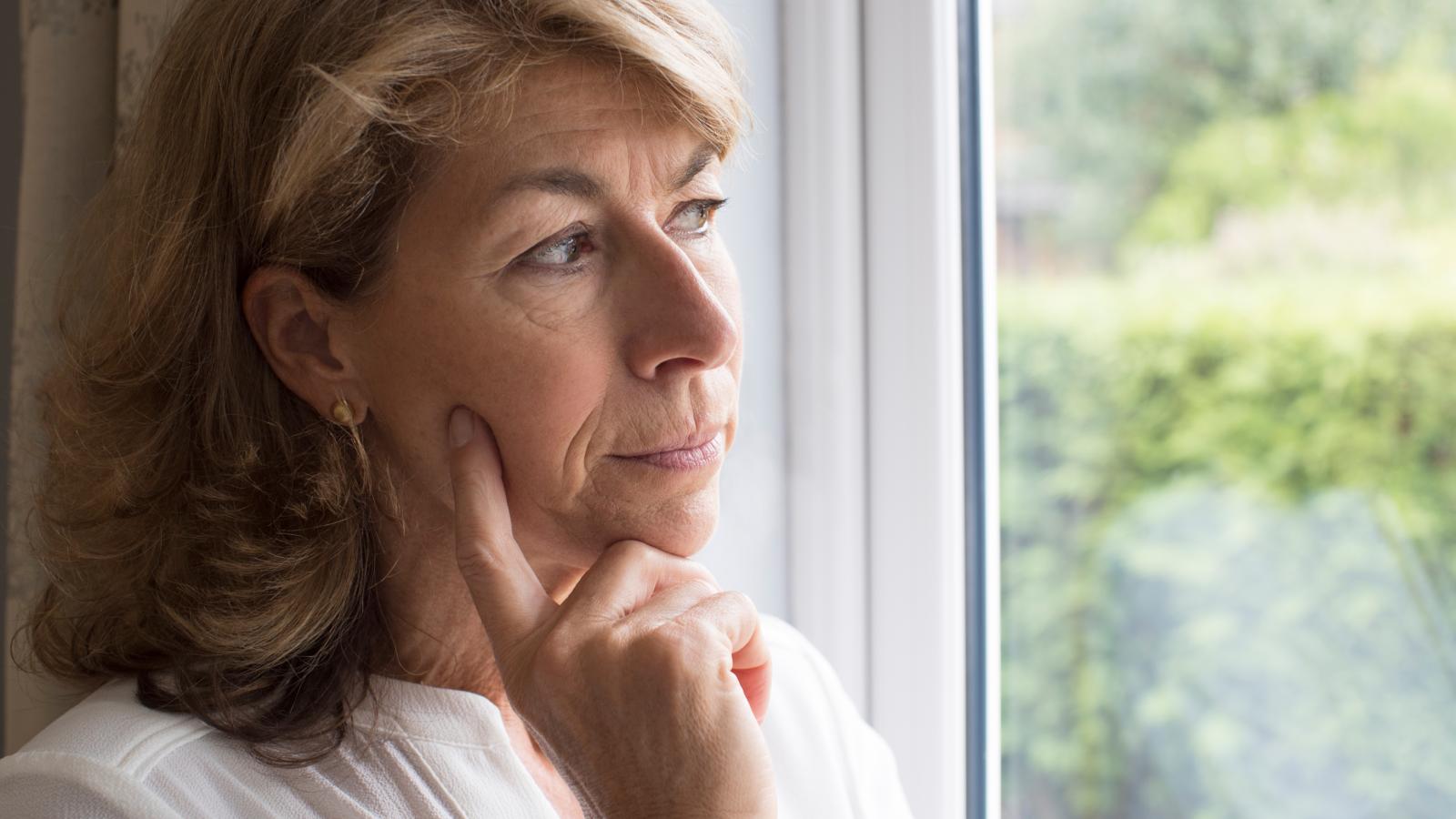 woman looking out a window