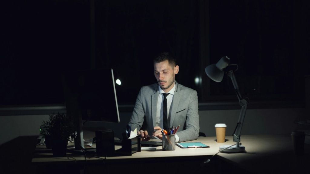 A man working at his desk at night
