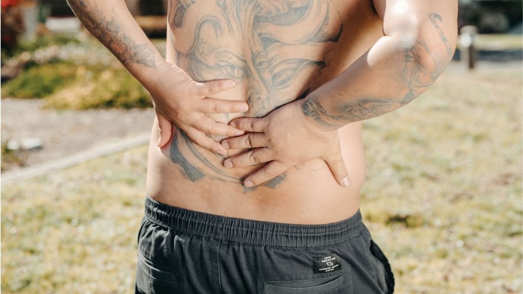 A guy holding his back