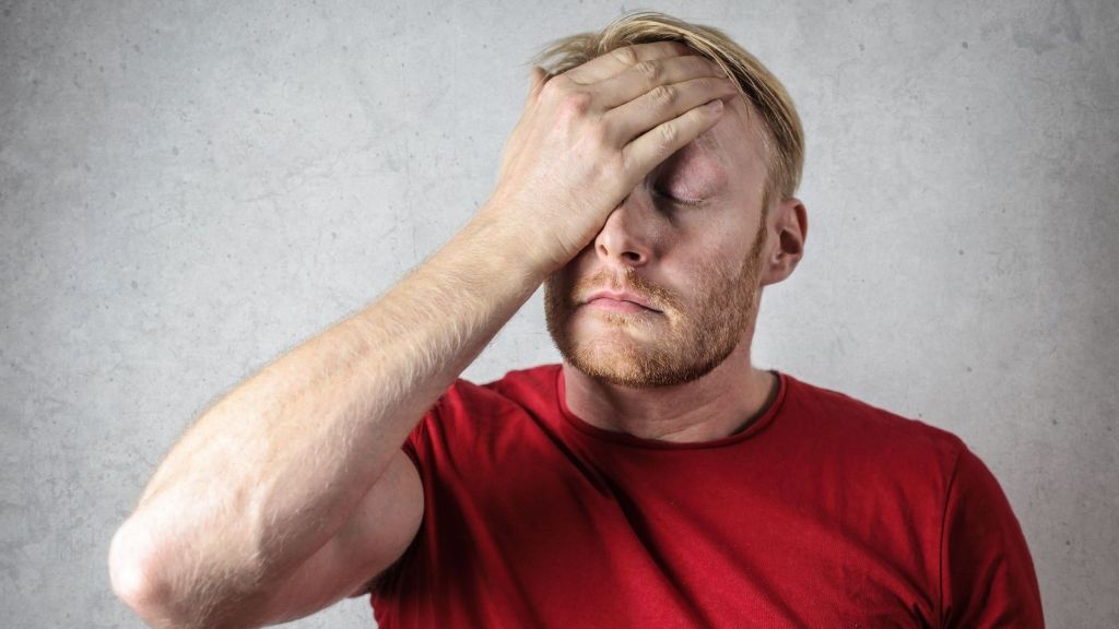 Man with his hand on his forehead