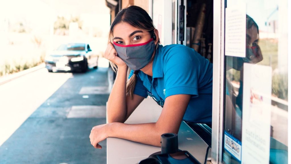 A woman working at a fast food drive through