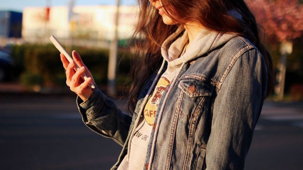 A teenage girl using her phone