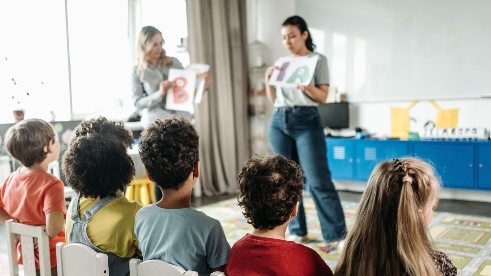 Two kindergarten teachers in front of a class