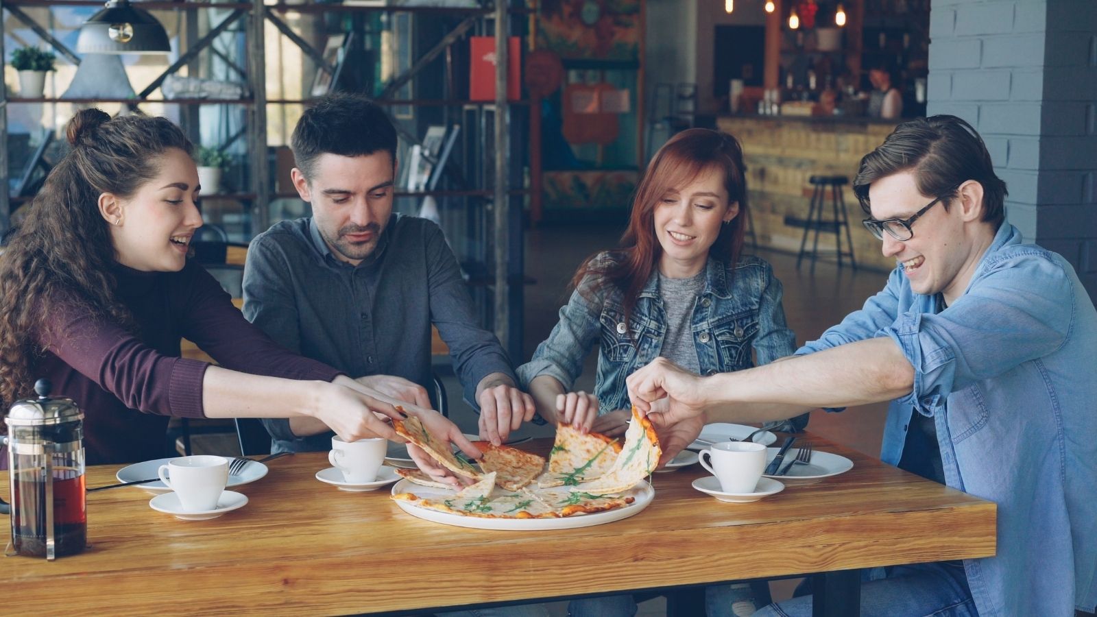 Adults sharing a pizza
