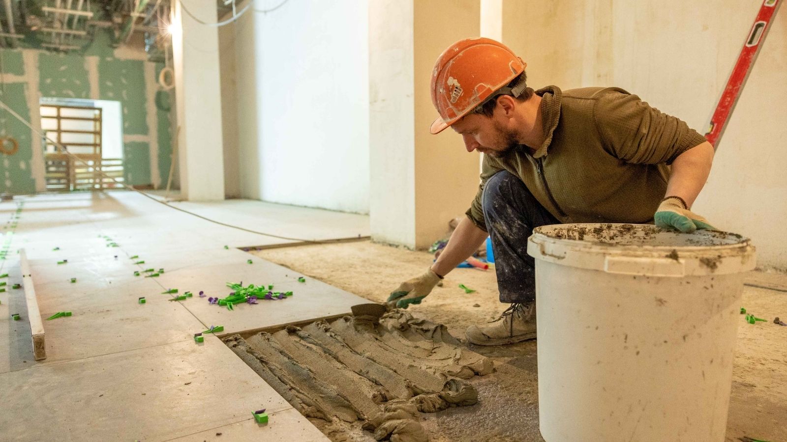 A guy laying flooring