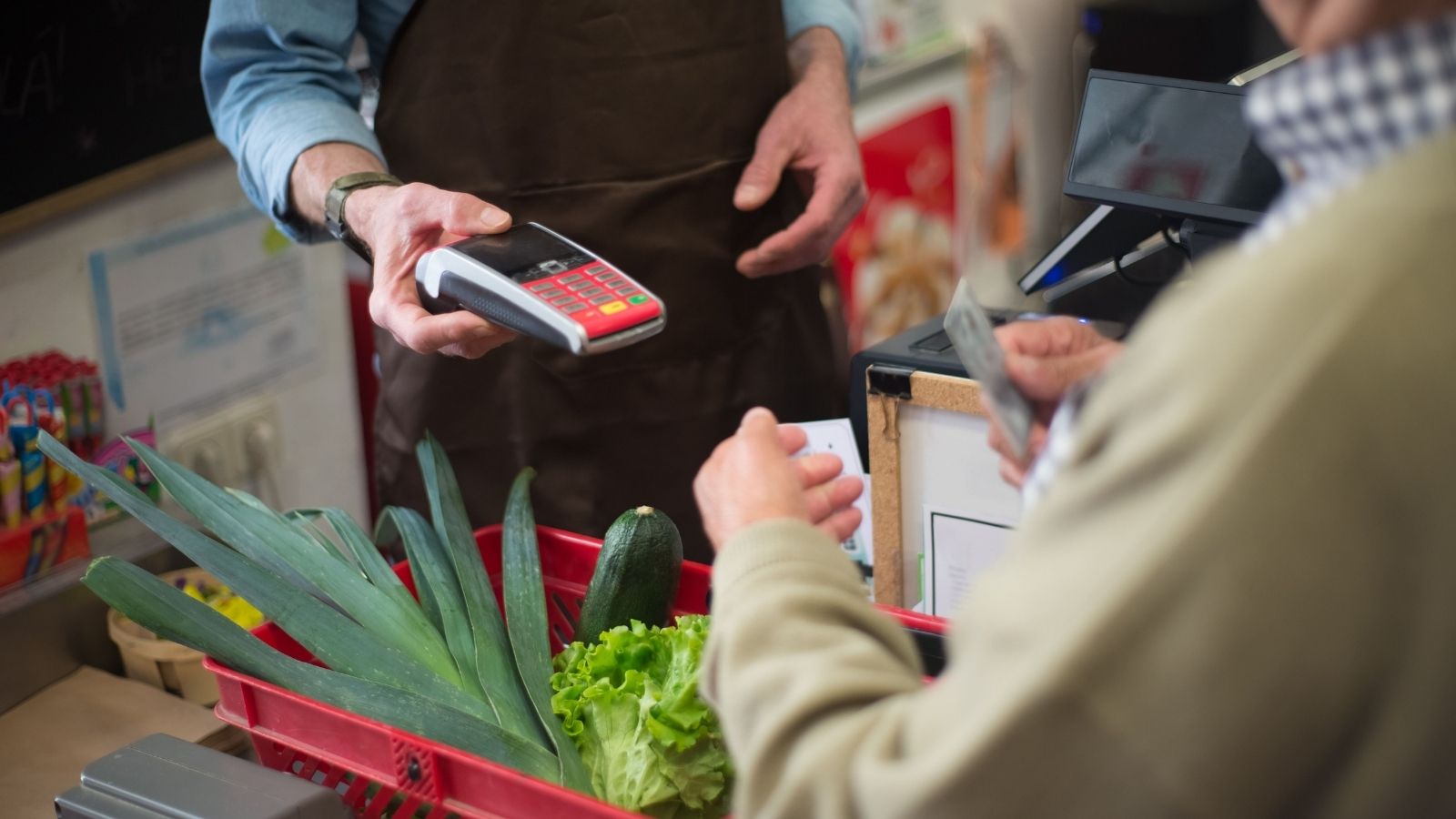 Grocery Store Service Desk Employee Had a Long Daily List of Responsibilities, but Two Customers Were Convinced They Did Nothing All Day A check out operator with a card machine