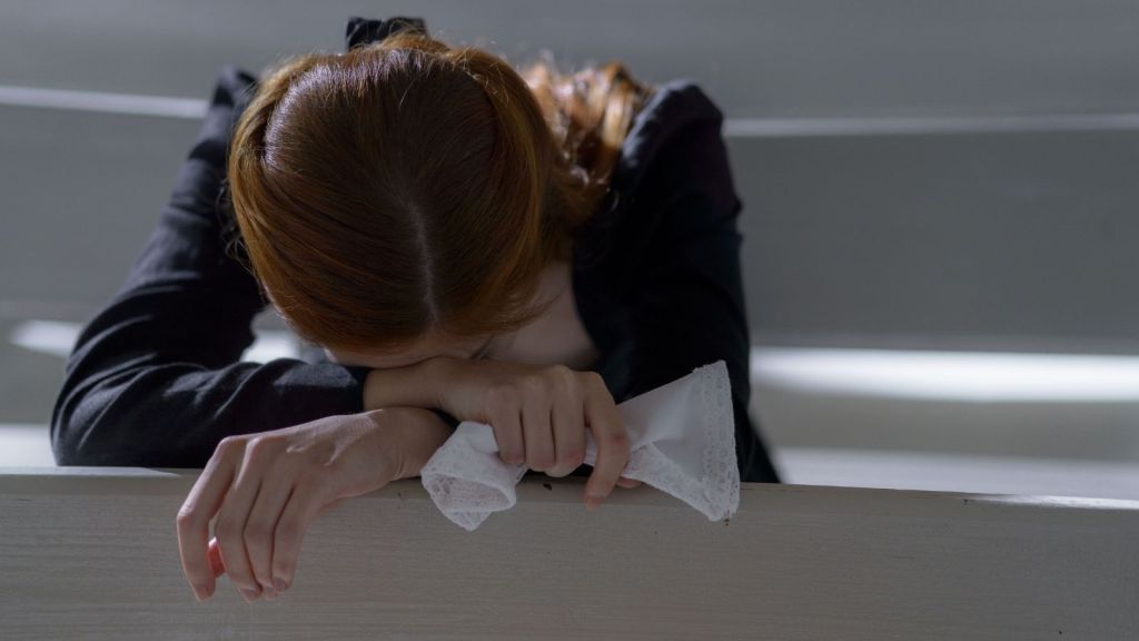 A woman in mourning dress crying