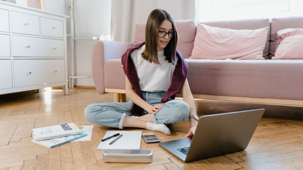 A teen studying with a laptop