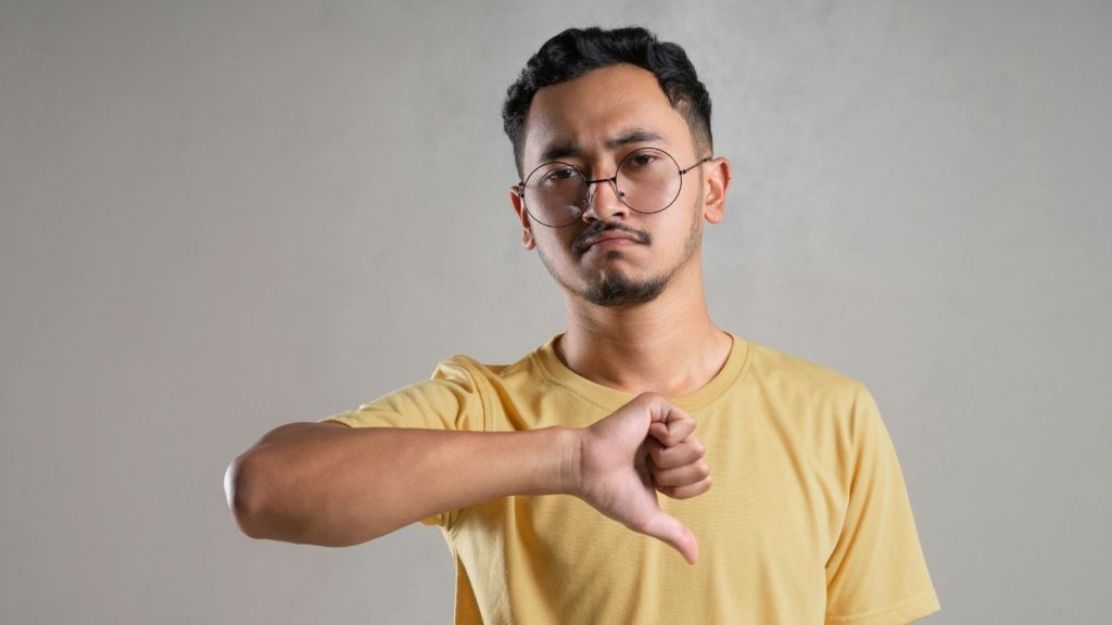 A guy giving a thumbs down