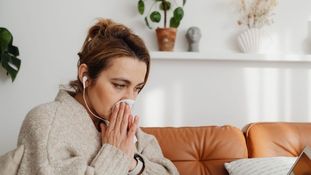 A woman blowing her nose