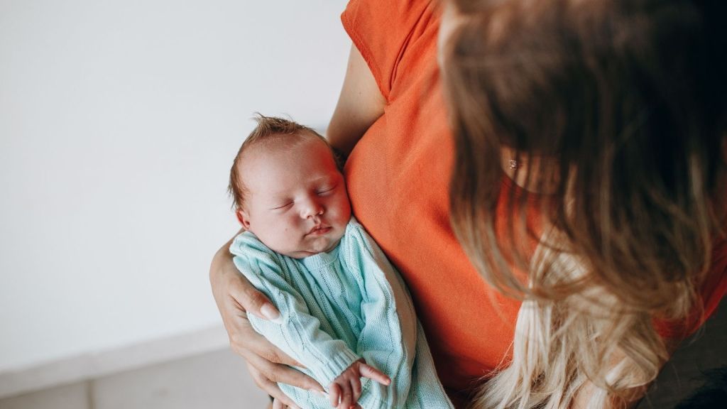A woman holding a newborn