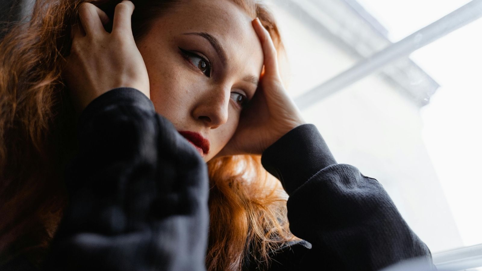A woman with her head in her hands