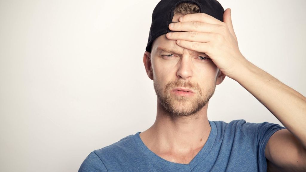 A guy with his hand on his forehead
