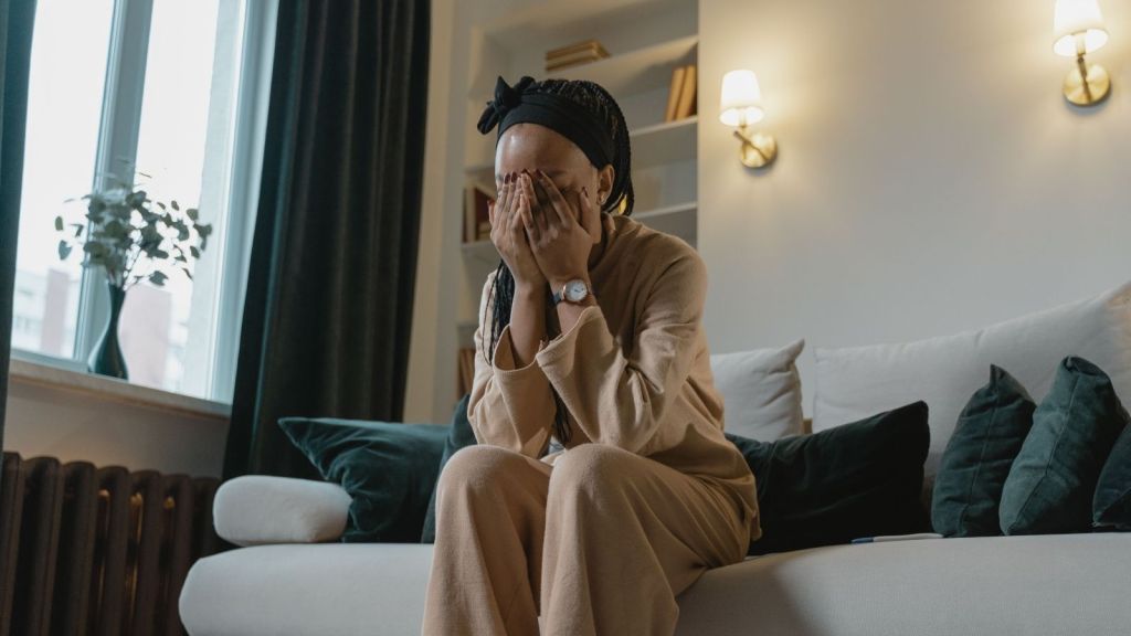 A woman with her head in her hands