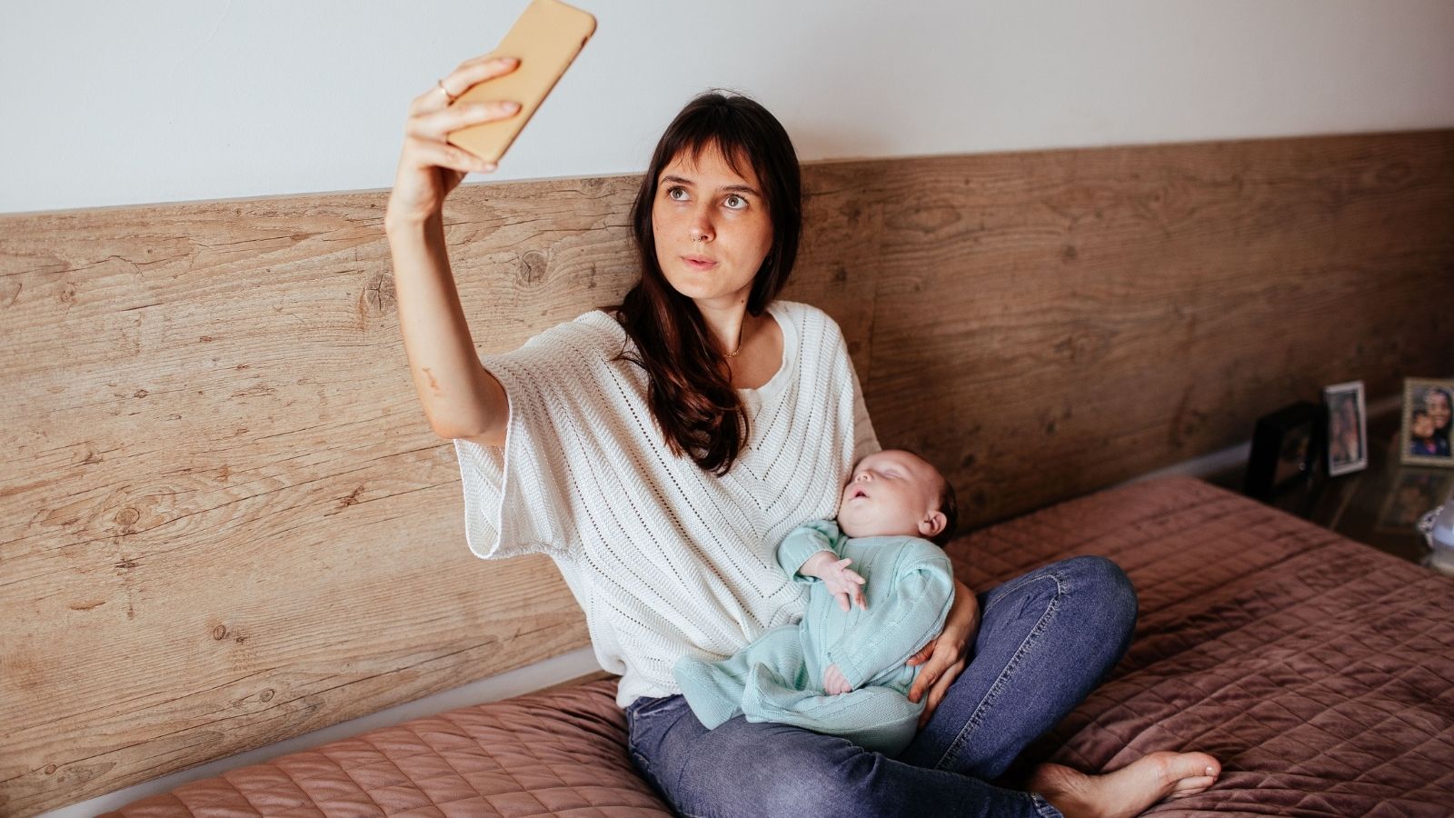 She Had a Deadline. Her Coworker Wouldnt Stop Talking About Her Baby. Putting Her Foot Down Made Everything Worse. A woman taking a selfie with her baby