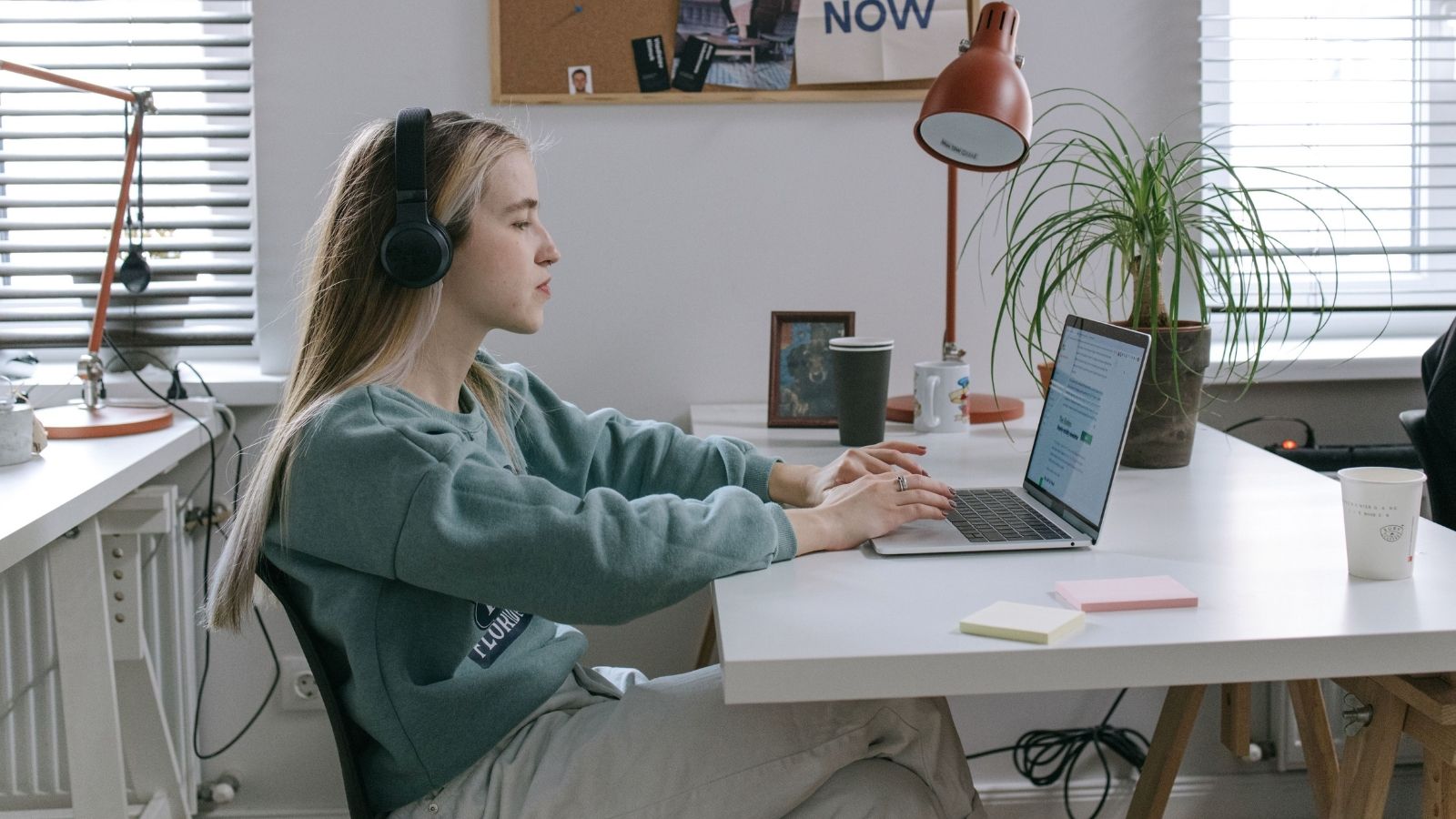 Interns Incredible Work Ethic Backfires After Manager Accuses Them of Trying to Oust the Staff A young woman working at a laptop in an office