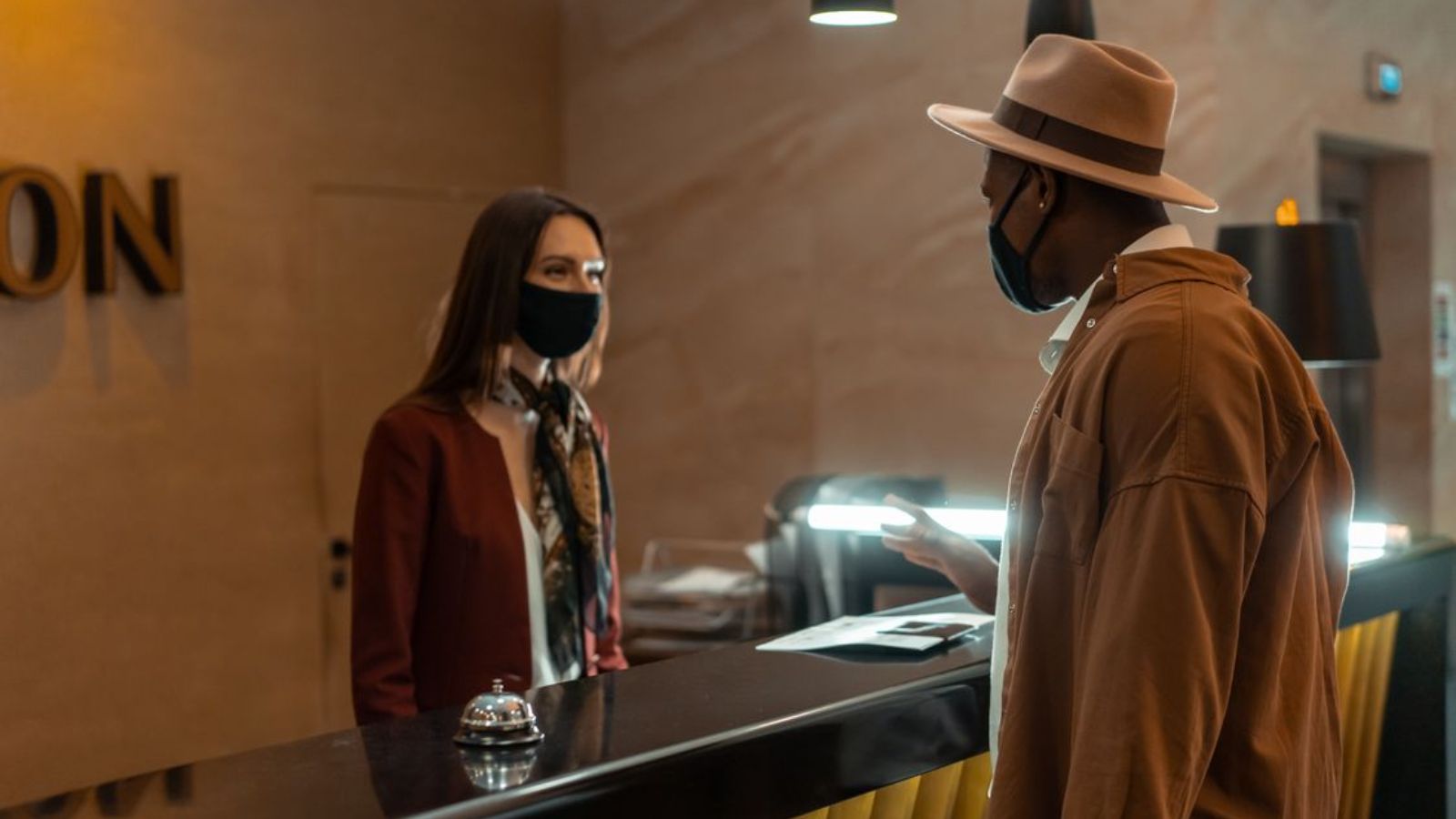 customer checking in at hotel reception