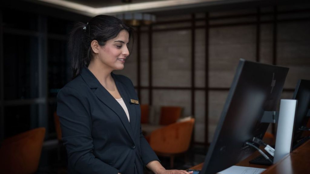 Front desk employee working at a hotel reception