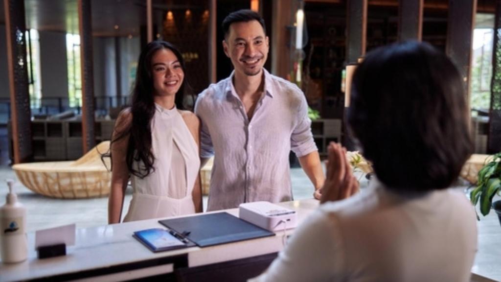 Couple checking in at hotel