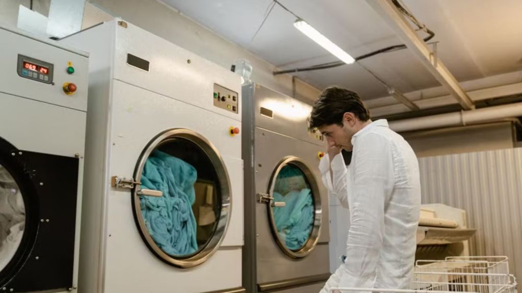 Man waiting for his laundry to finish