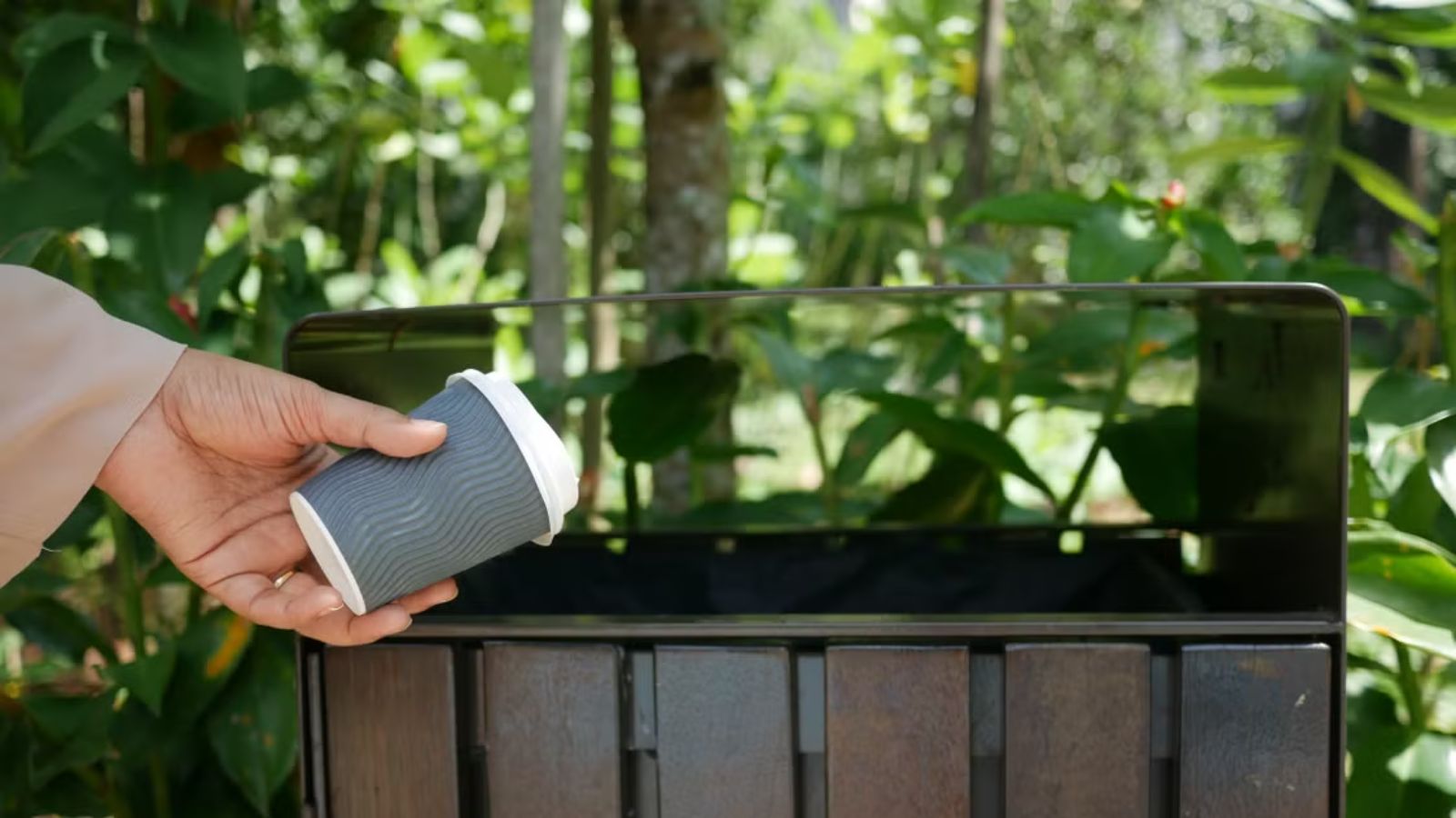 He Reported a Receptionist for Being Rude During His Volunteer Shift — Then Somehow Became the One Accused Person throwing an empty coffee cup into the trash bin