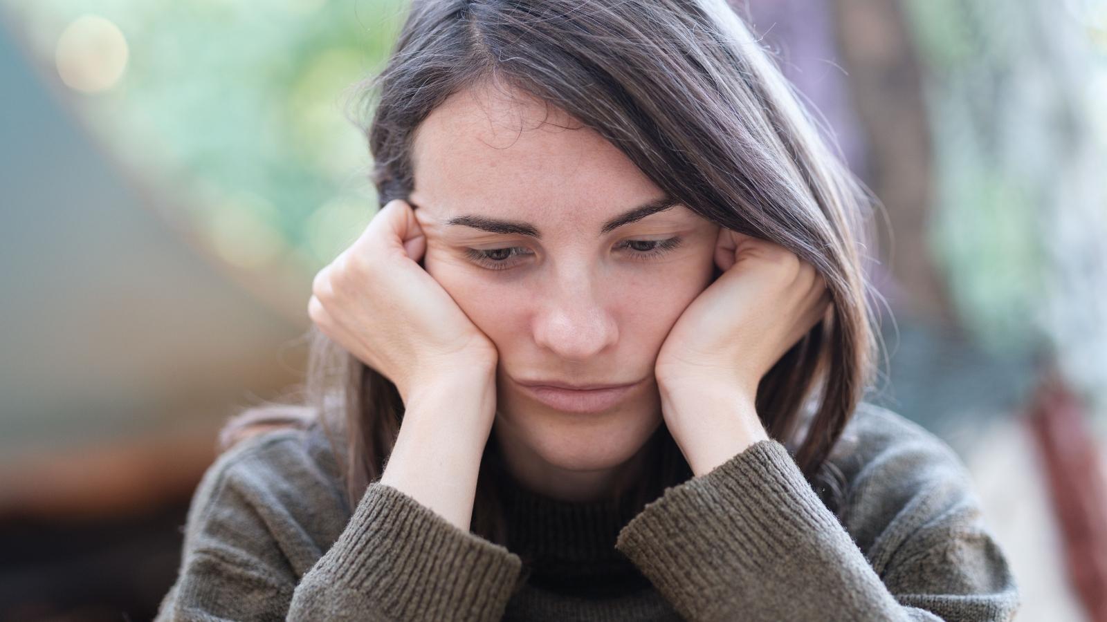 Her Desire to Meet New People on Her Own Was Meant to Build Confidence—Until Her Best Friend Took Offense Portrait of a young woman looking pensive and thoughtful while sitting outdoors