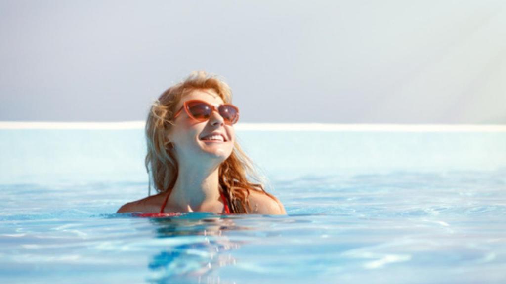 Woman swimming in hotel pool