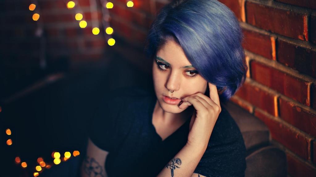 Woman with purple hair thinking about work