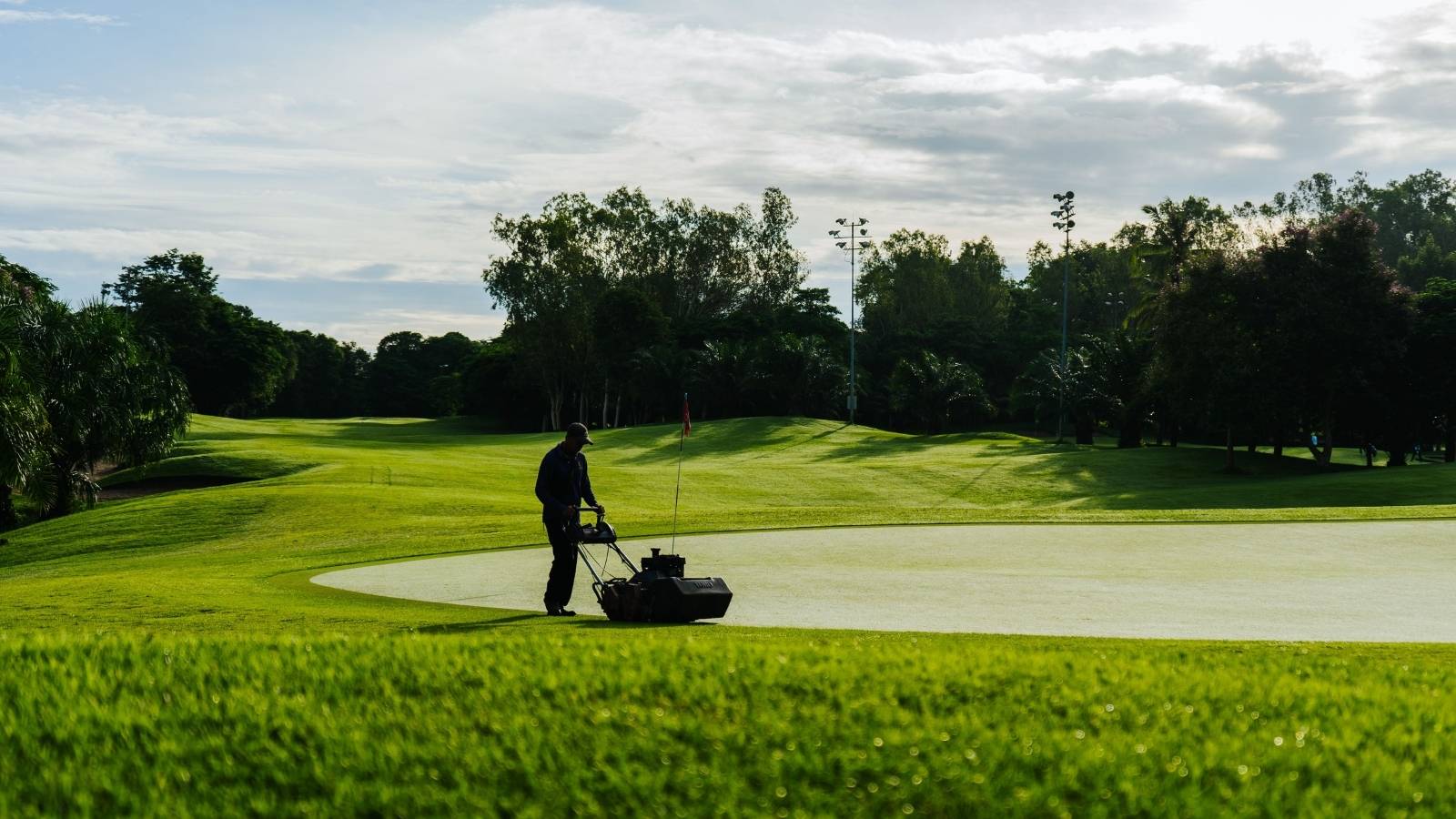 Man mowing grass at a golf course