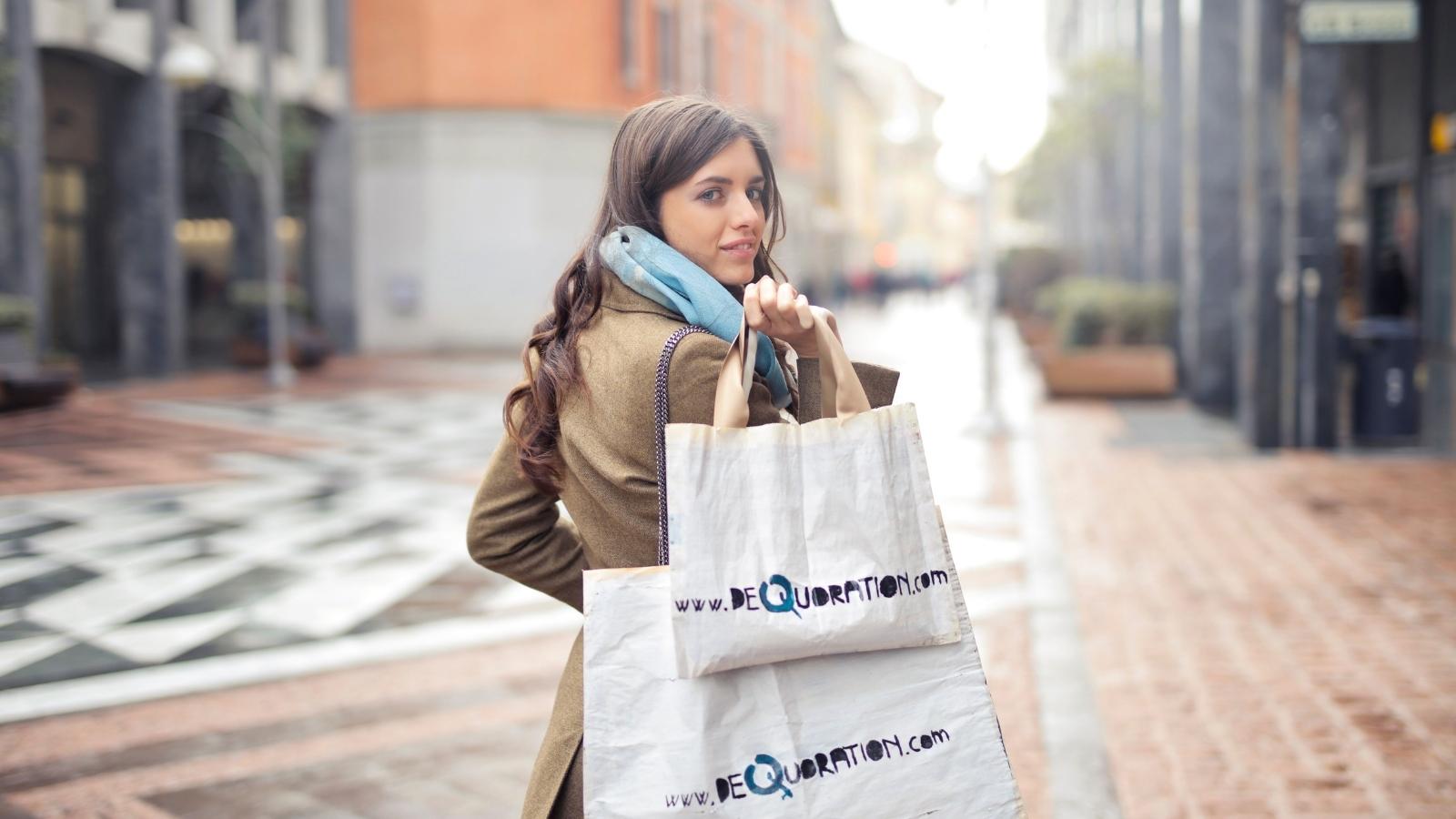 Woman Shops for an Electronic Device and Politely Declines an Extended Warranty, but an Employee’s Rude Response Leads to a Complaint to His Manager Woman walking away with shopping bags