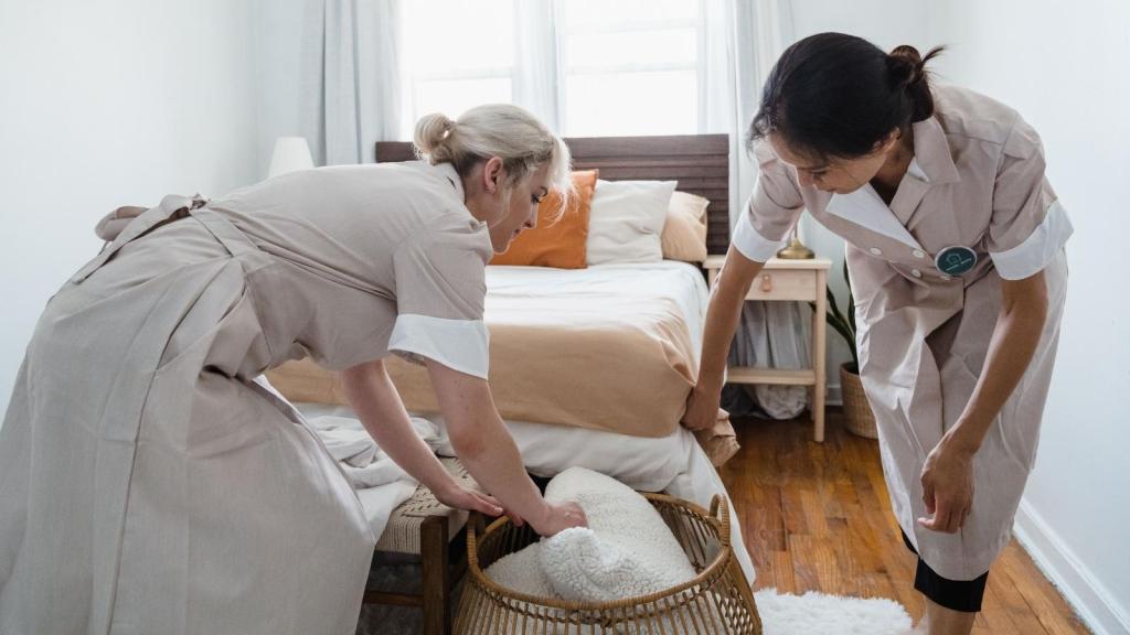 Housekeepers working together to clean a room