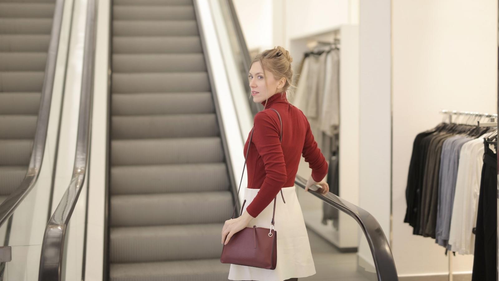 Stranger Corners Teen at the Cash Register Over Using Her Dads Credit Card Woman riding the escalator in a large store