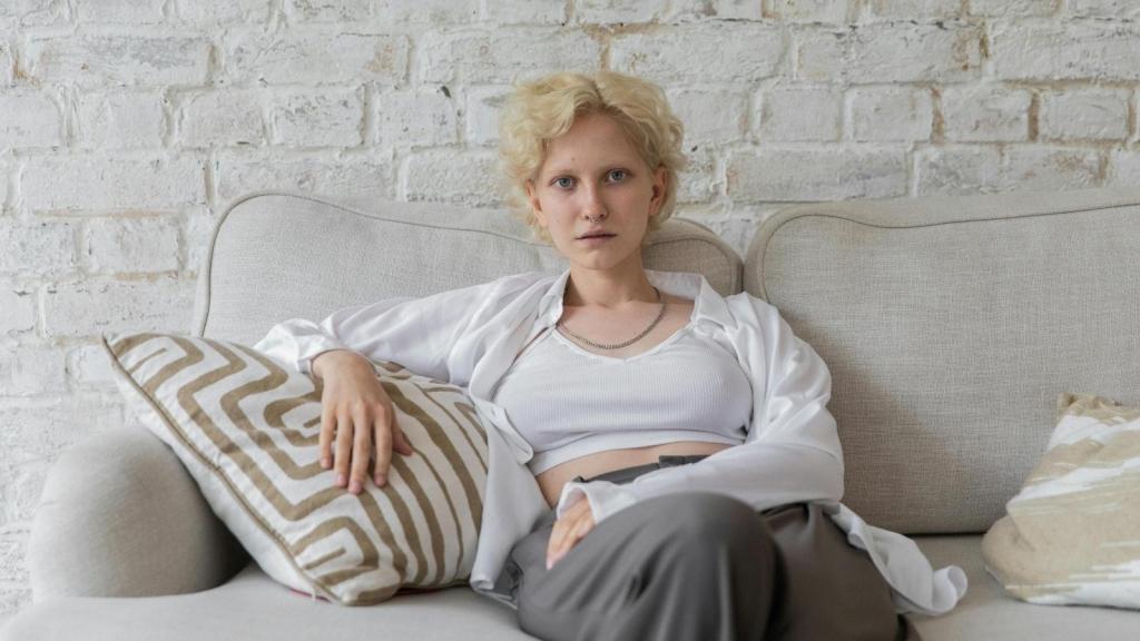 Woman sitting on couch thinking