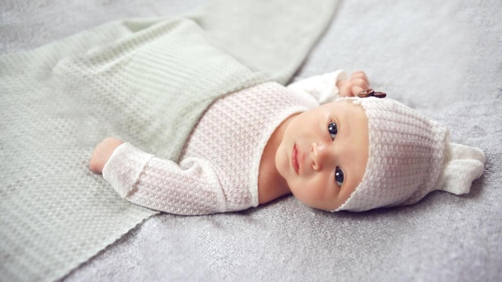 Preemie girl laying on a soft blanket