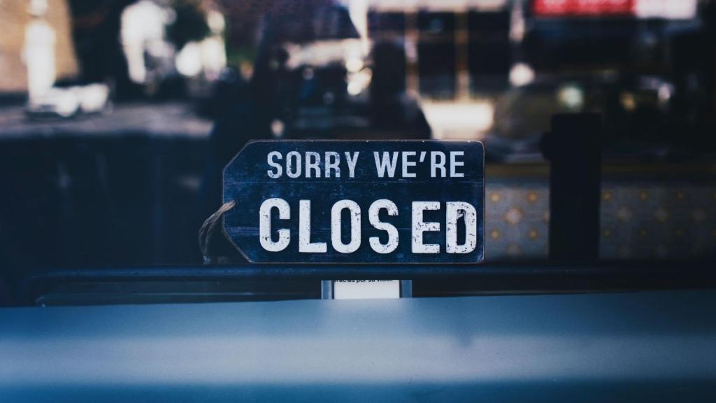 Sorry We're Closed sign in the window