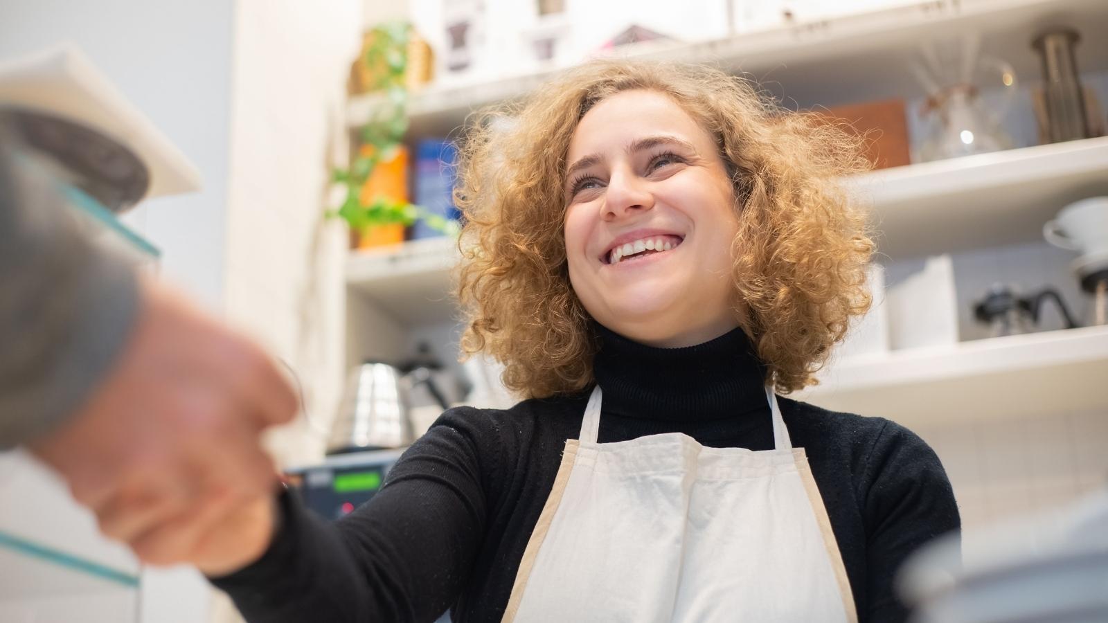 Cashier smiling at a customer