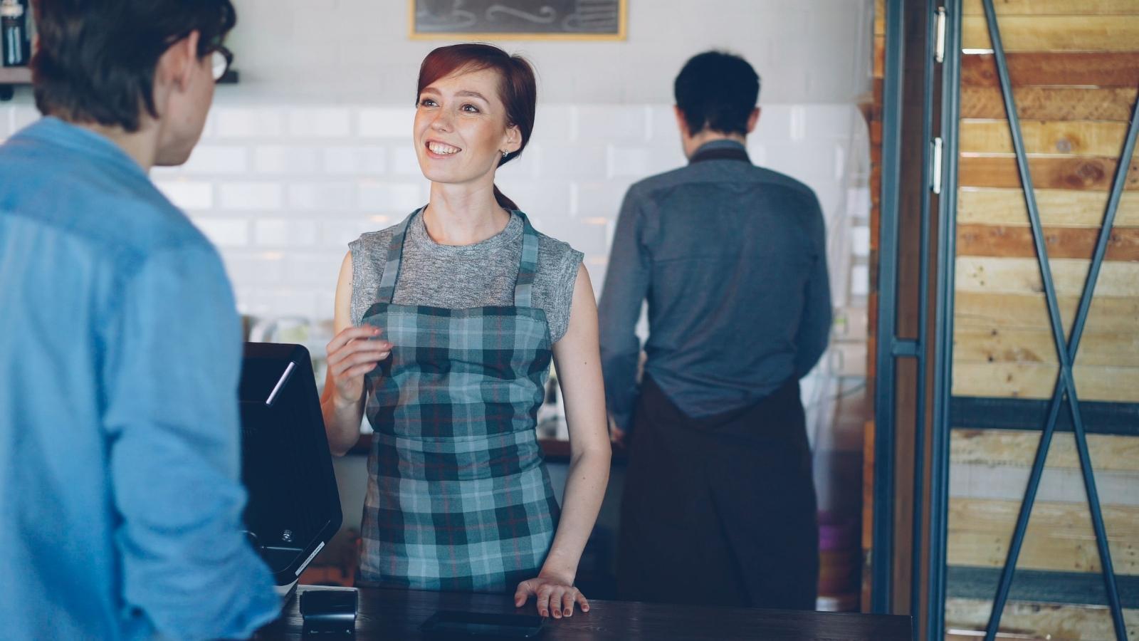Cashier smiling at a customer in the store