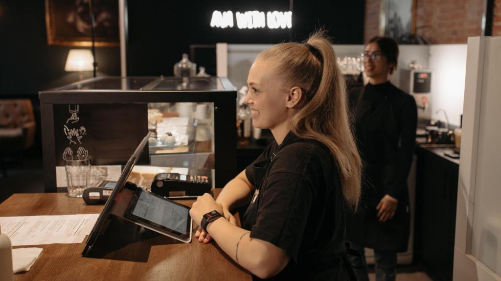 Two women baristas working at a local coffee shop