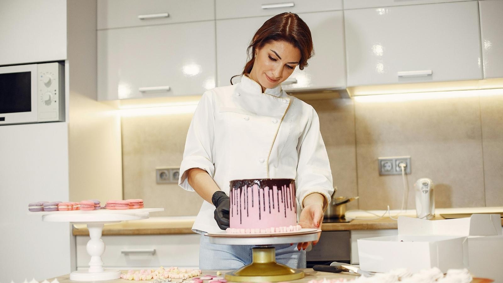 Woman working in a bakery making cakes
