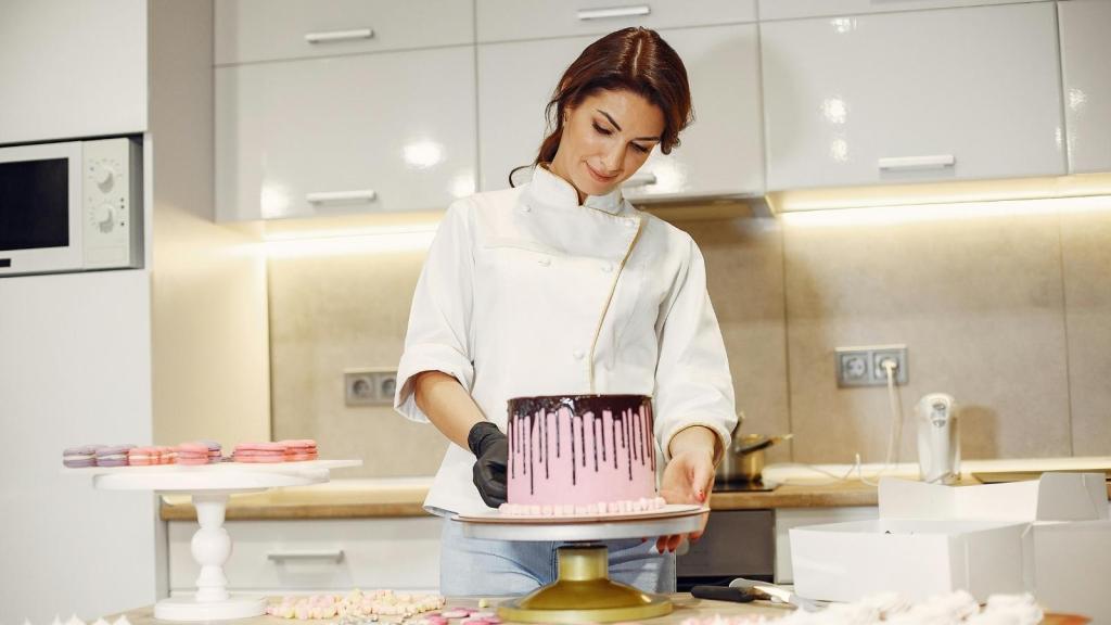 Woman working in a bakery making cakes