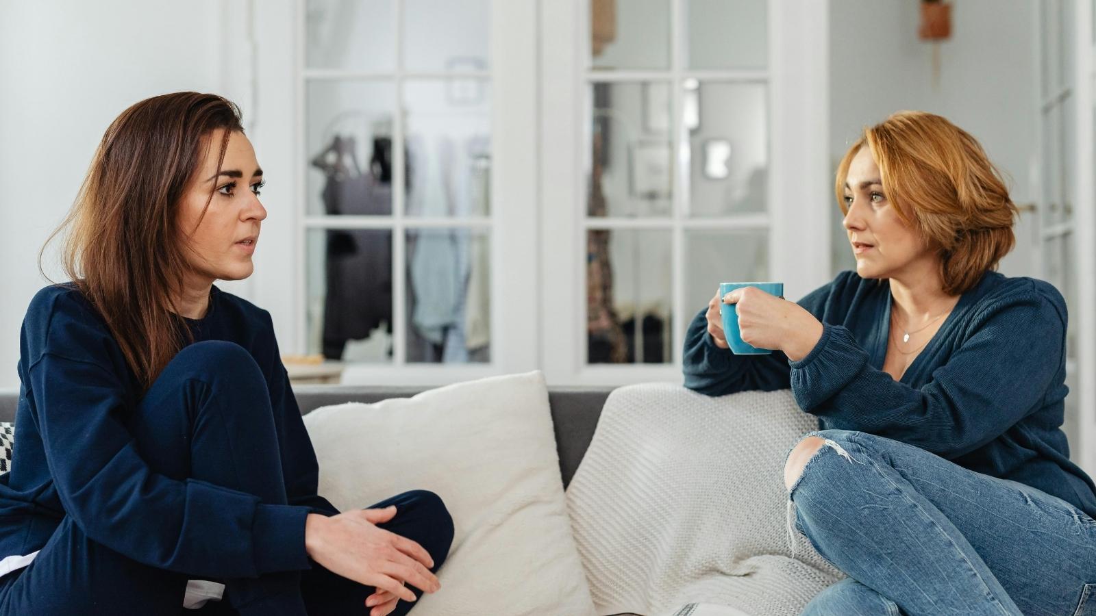 She Tried to Vent About Work, But Her Roommate Kept Accusing Her of Letting Her Boss Walk All Over Her Roommates talking on the porch