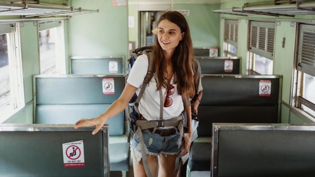 Woman boarding a train, looking for a seat