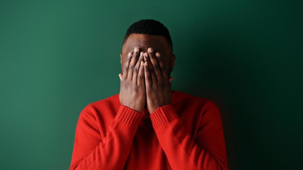 Man covering his face because he's embarrassed