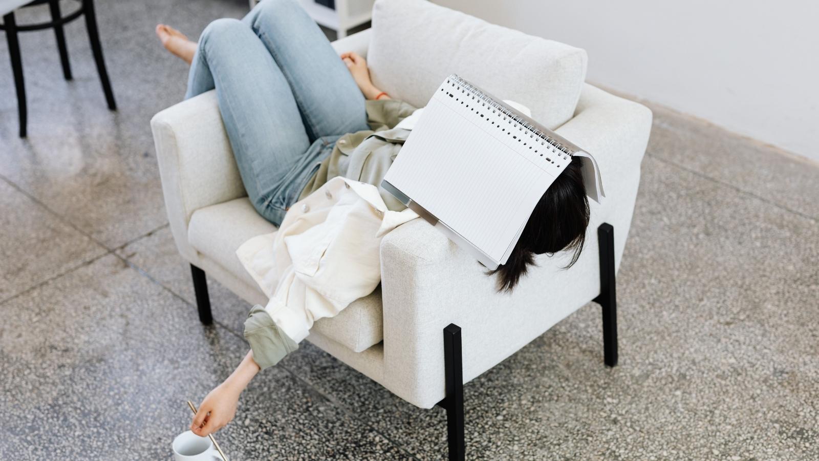 Woman tired in a chair trying to work