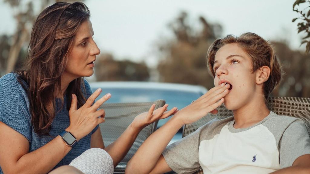Mother trying to talk to her son.