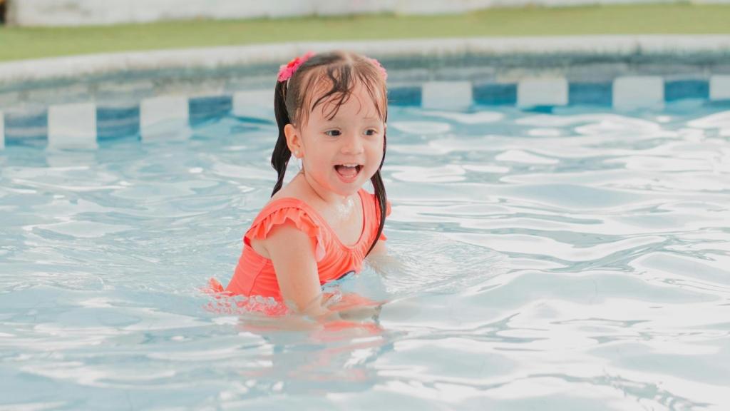 Little girl swimming in a pool
