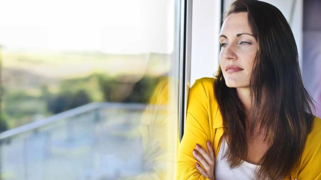 Woman looking out the window thinking