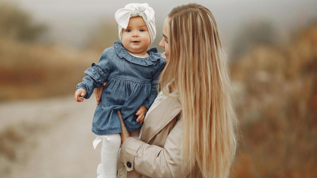 Young mother holding her little daughter